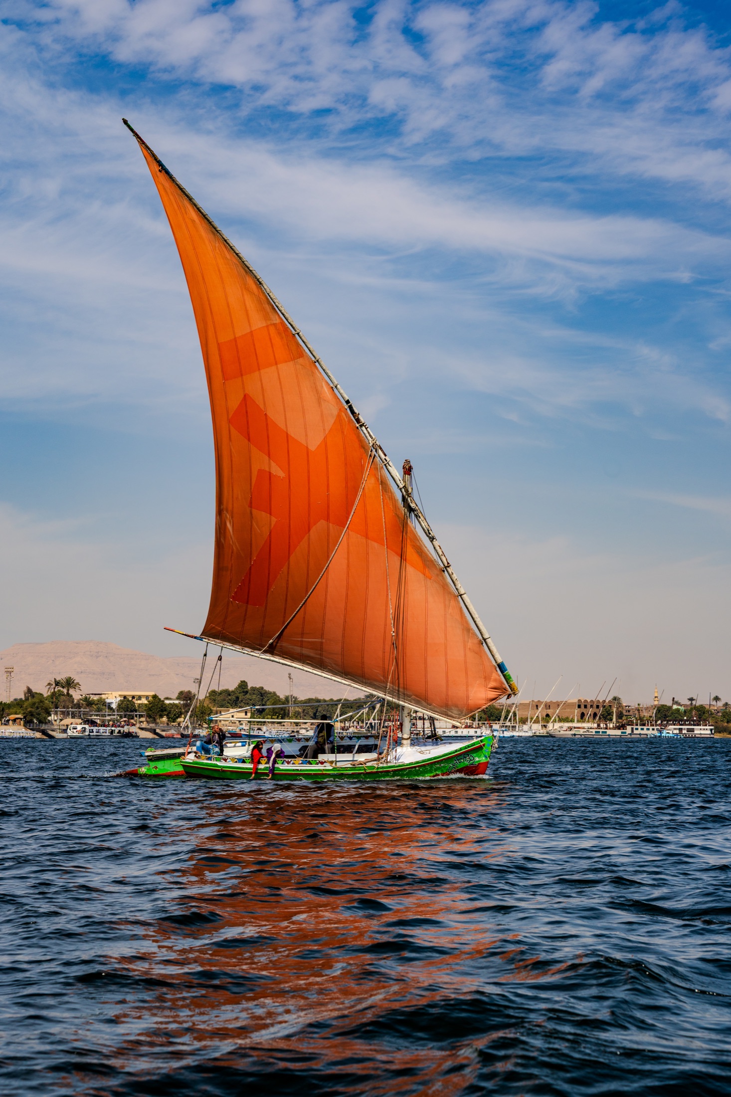 Felucca with orange sail on the Nile River
