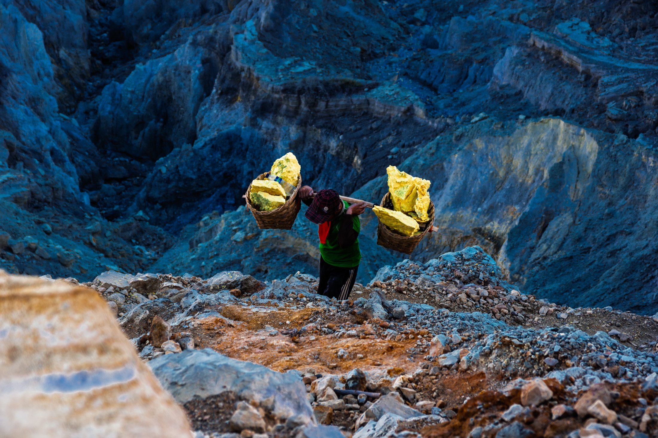 Sulfur miner silhouette in Kawah Ijen crater